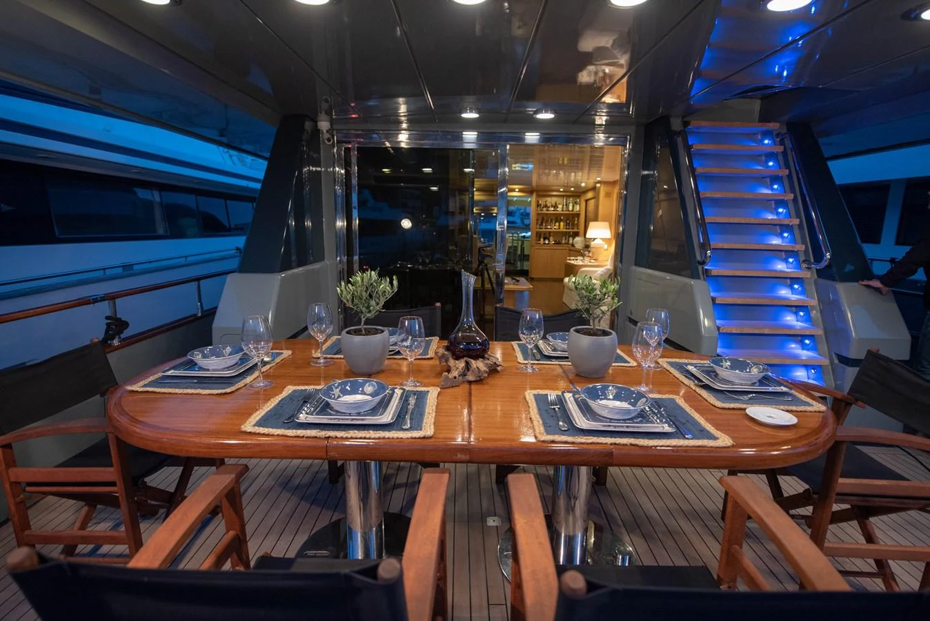 The yacht's dining area features a beautifully set table with elegant tableware, creating a cozy and inviting atmosphere. aboard KISS Yacht for Sale