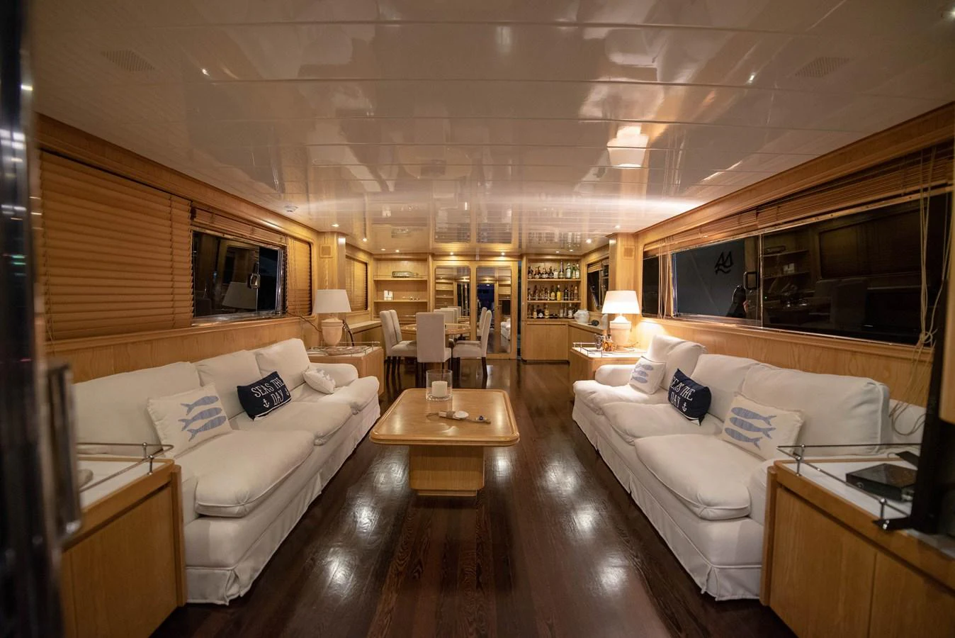 The yacht's salon features plush seating, warm lighting, and elegant wooden finishes, creating a cozy and inviting atmosphere. aboard KISS Yacht for Sale