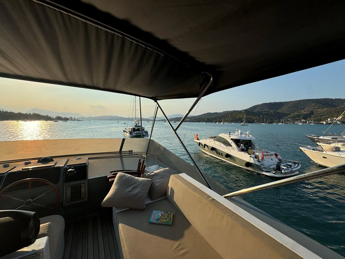 The aft deck offers a serene view of the surrounding waters and nearby yachts, perfect for relaxation. aboard KISS Yacht for Sale