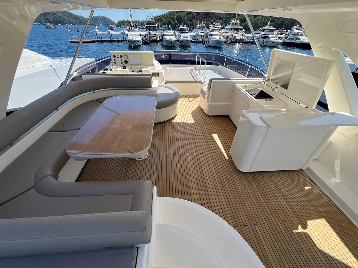 a boat dock with a large body of water and boats in the background aboard NGV Yacht for Sale