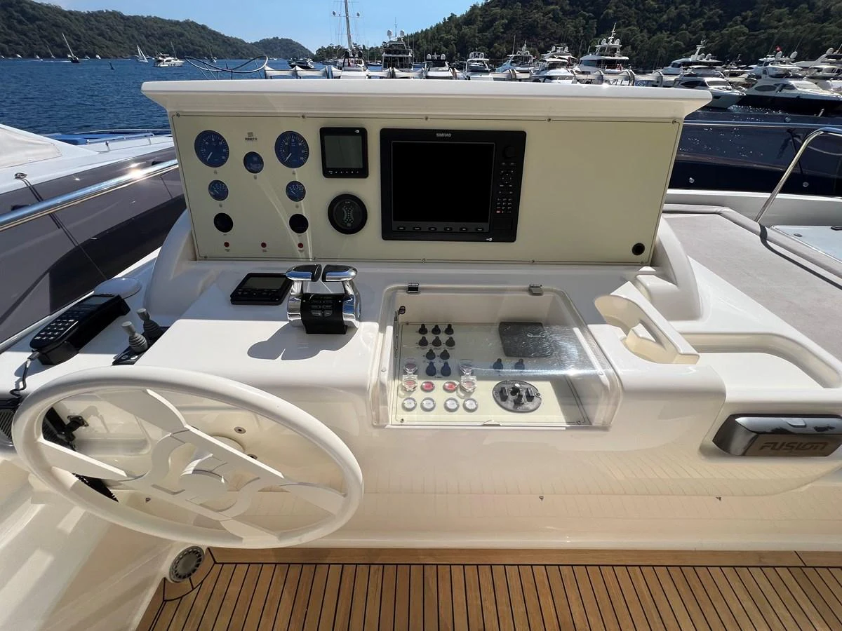 a white boat with a black and white radio on it aboard NGV Yacht for Sale