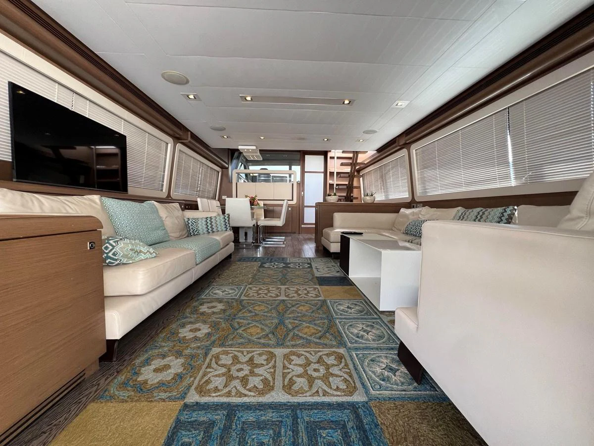 a room with a couch and a bed aboard NGV Yacht for Sale