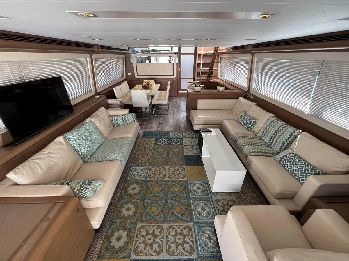 a living room with a blue rug aboard NGV Yacht for Sale