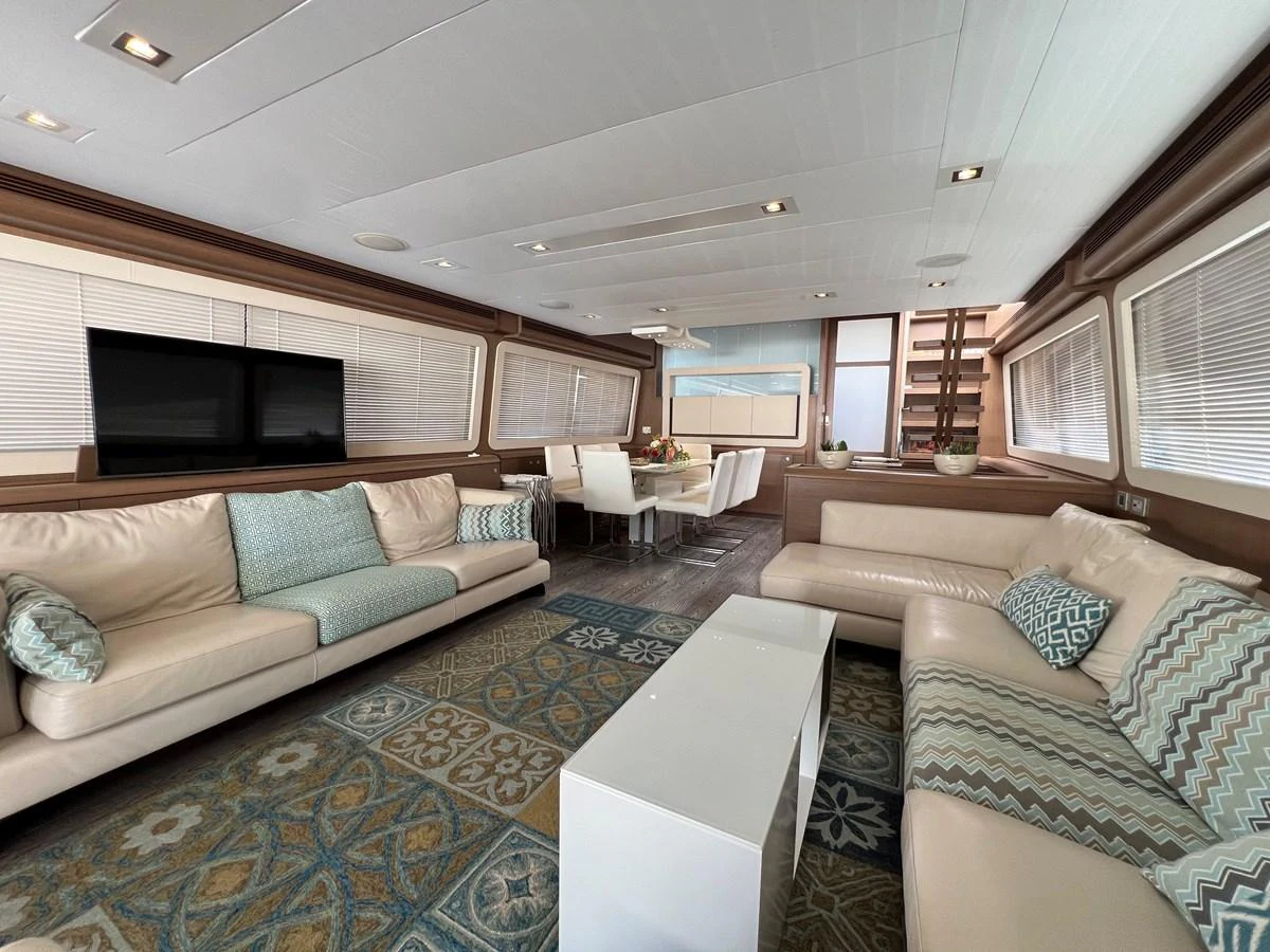 a living room with a couch and a tv aboard NGV Yacht for Sale