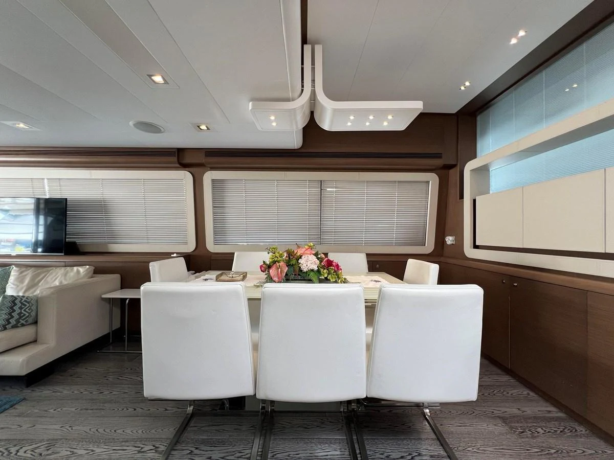 a white dining table in a room aboard NGV Yacht for Sale