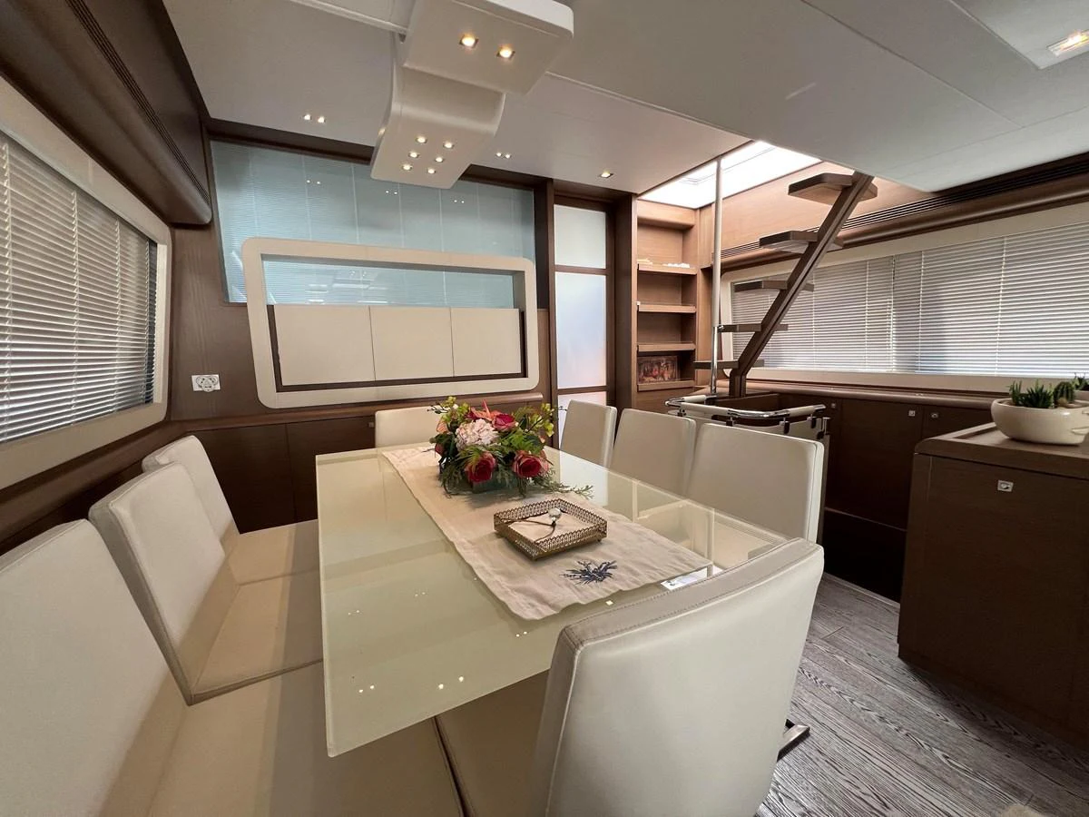 a room with a table and chairs aboard NGV Yacht for Sale