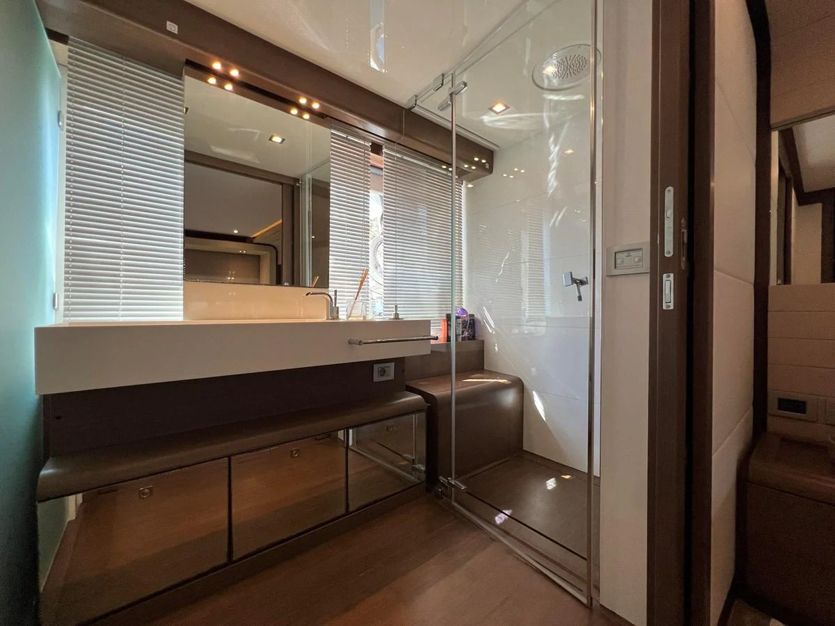 a bathroom with a glass shower aboard NGV Yacht for Sale