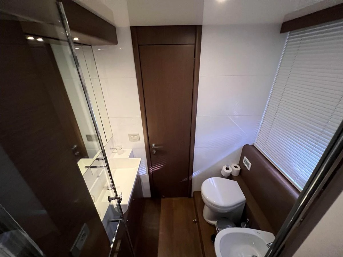 a bathroom with a glass shower aboard NGV Yacht for Sale