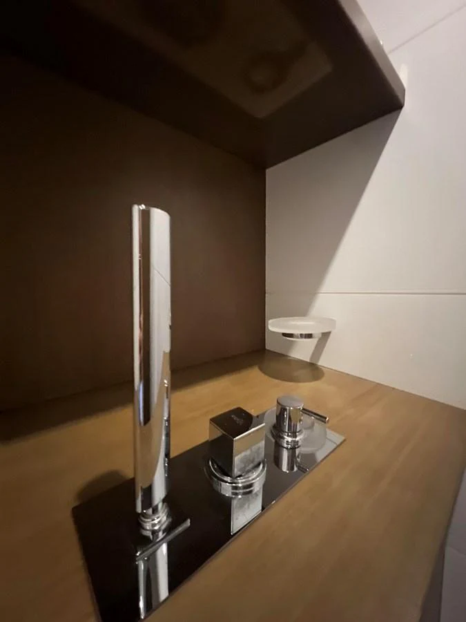 a silver and black kitchen utensil on a black table aboard NGV Yacht for Sale