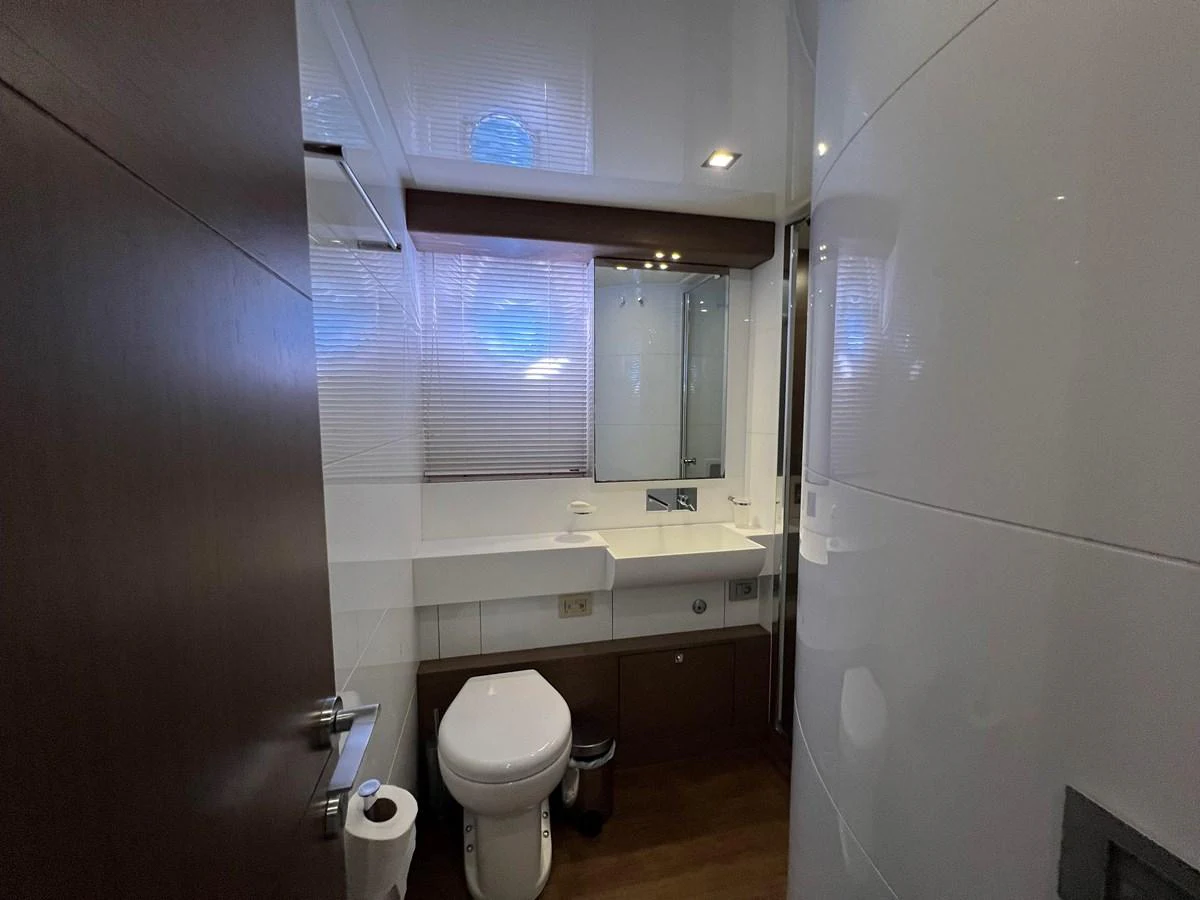 a bathroom with a toilet and a sink aboard NGV Yacht for Sale