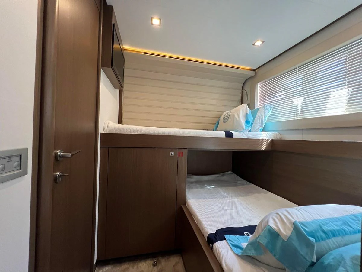 a room with a bed and a closet aboard NGV Yacht for Sale