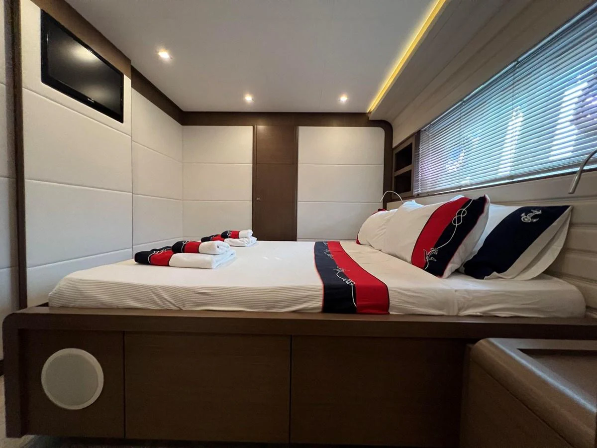 a room with a bed and a window aboard NGV Yacht for Sale
