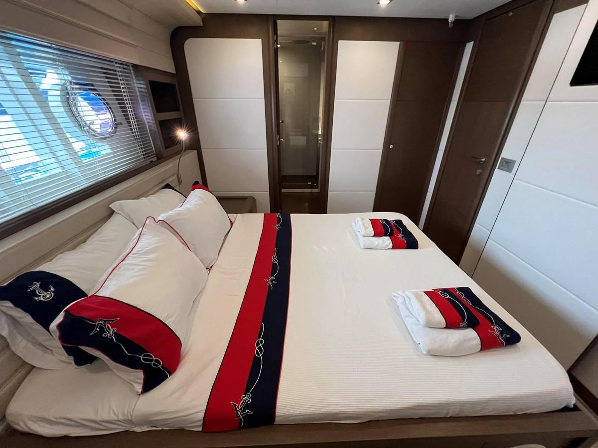 a room with a bed and a window aboard NGV Yacht for Sale