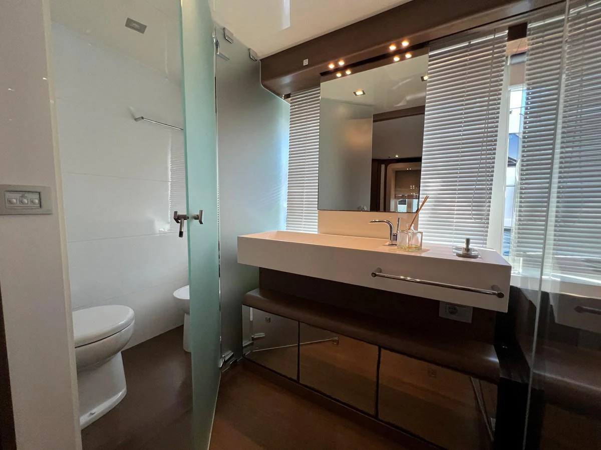 a bathroom with a countertop sink and a mirror aboard NGV Yacht for Sale