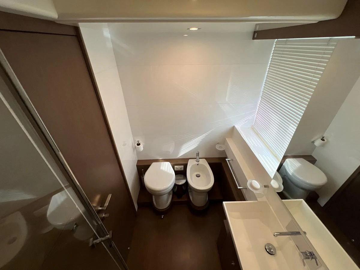 a bathroom with a toilet and a sink aboard NGV Yacht for Sale