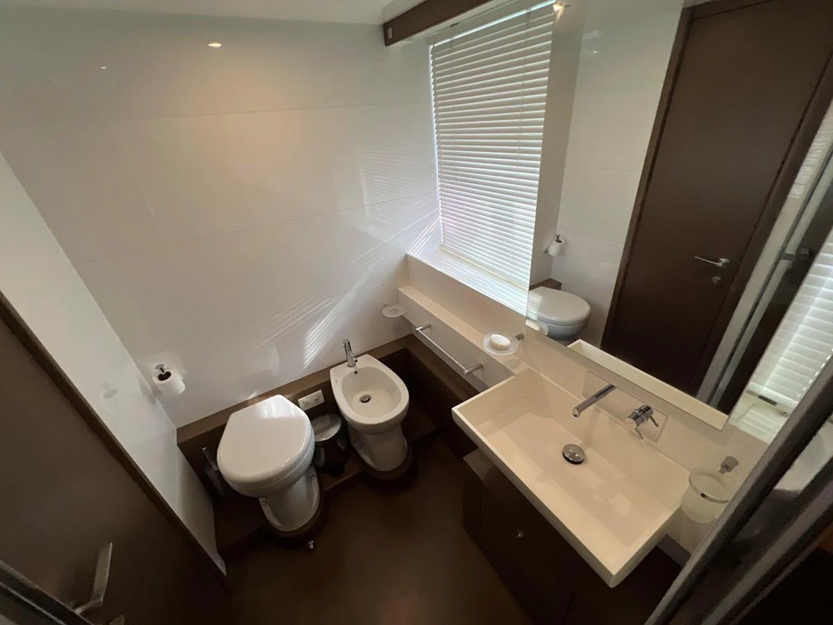 a bathroom with a sink toilet and a bathtub aboard NGV Yacht for Sale