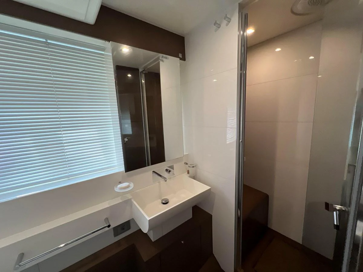 a bathroom with a sink and a mirror aboard NGV Yacht for Sale