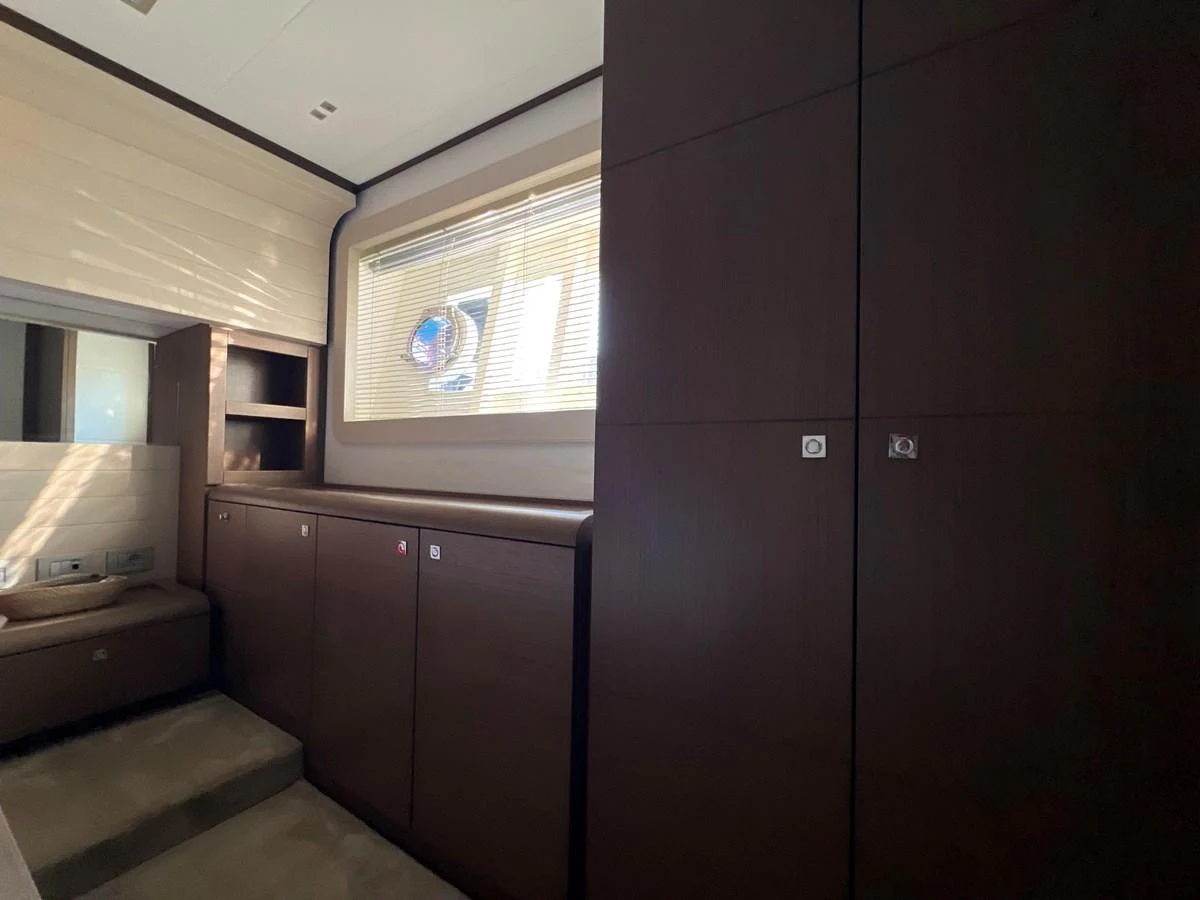 a room with a window and a desk aboard NGV Yacht for Sale