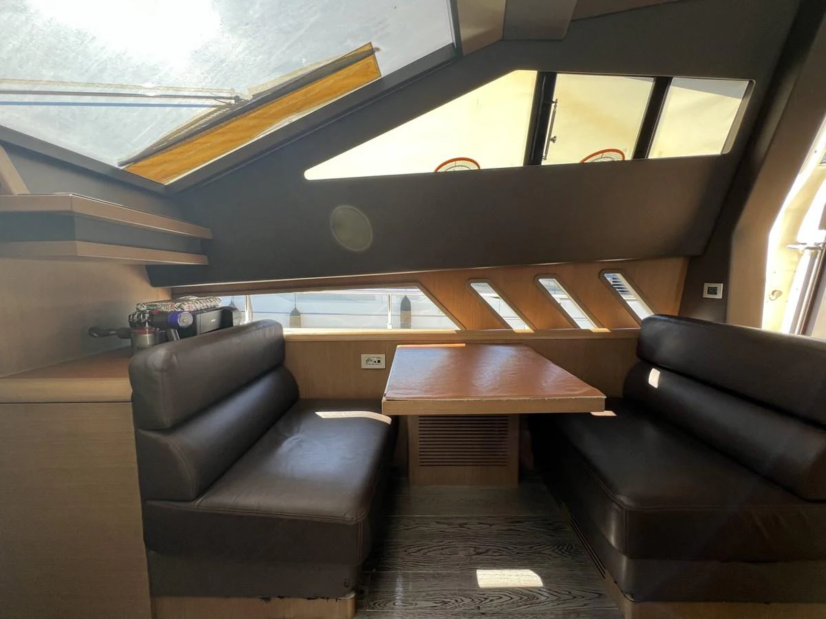 a room with couches and a table aboard NGV Yacht for Sale