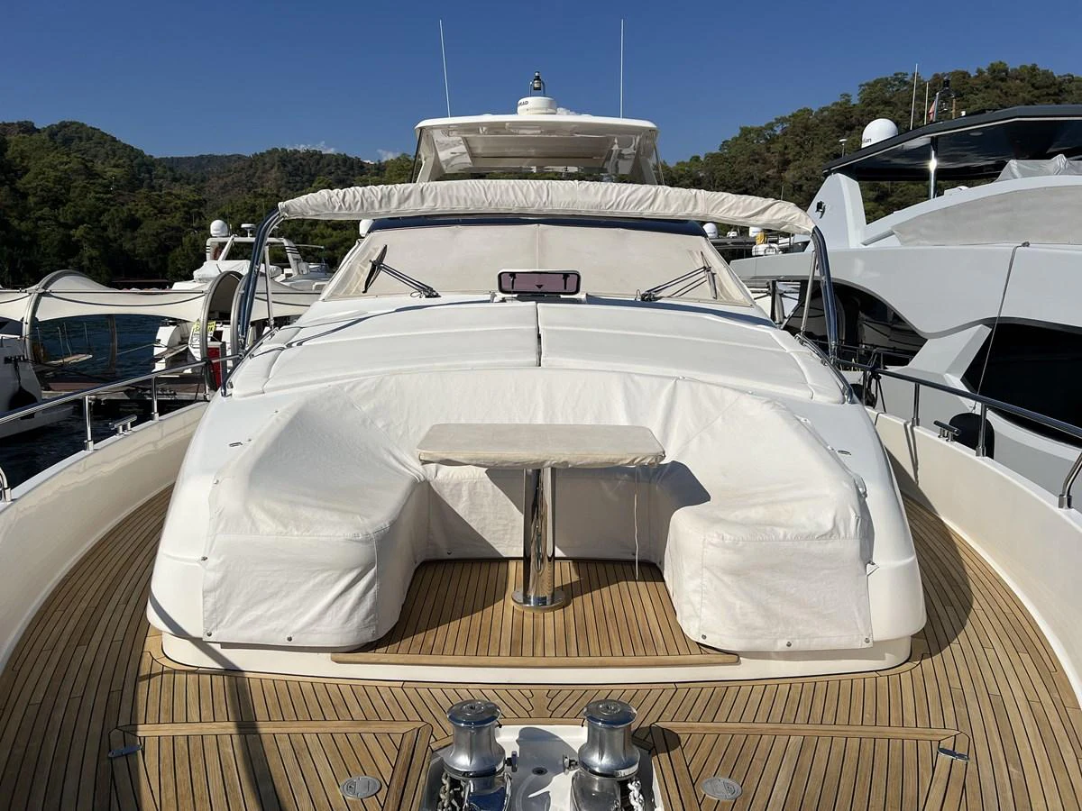 a white boat with a white canopy aboard NGV Yacht for Sale