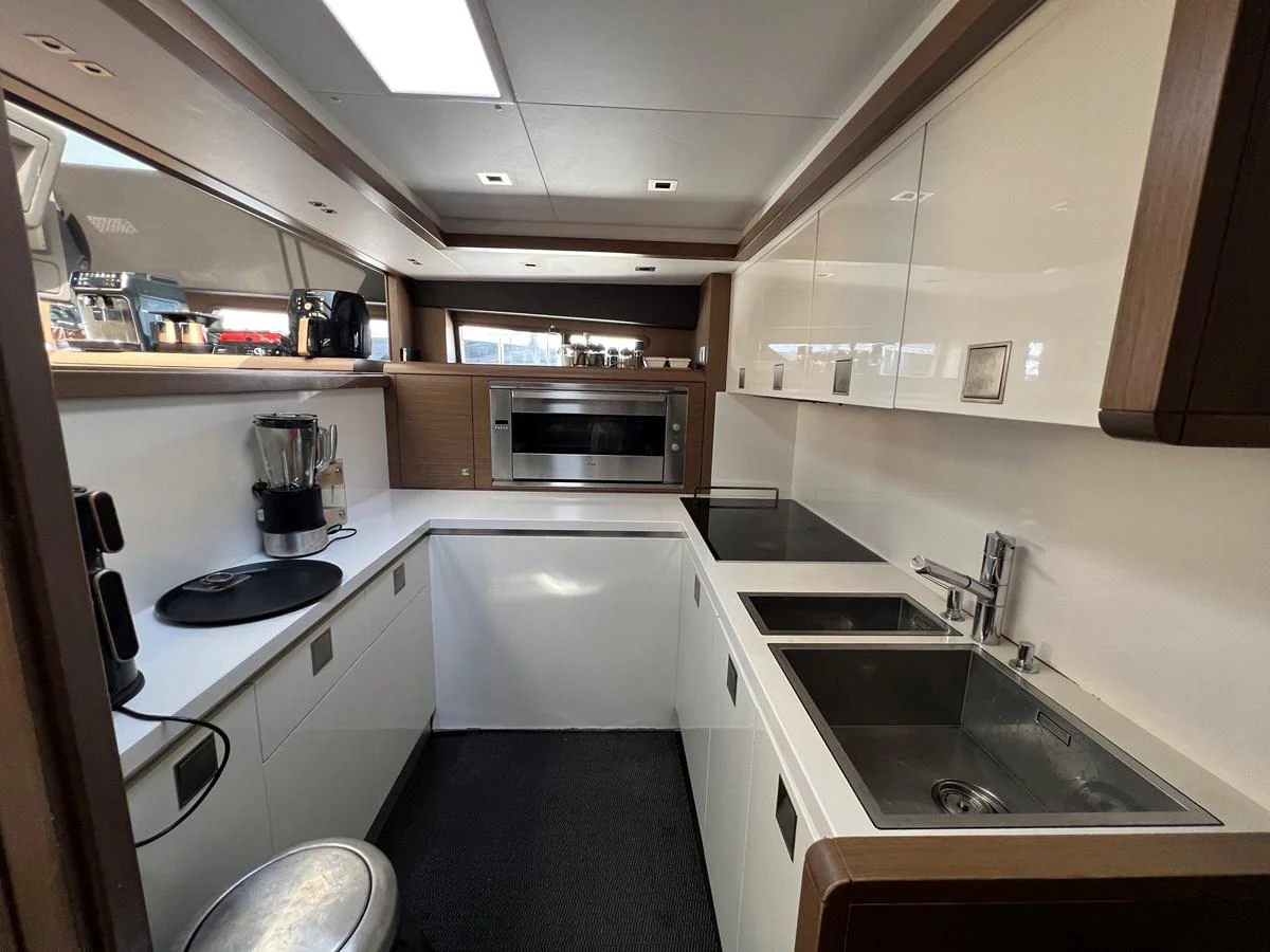 a kitchen with a sink and microwave aboard NGV Yacht for Sale