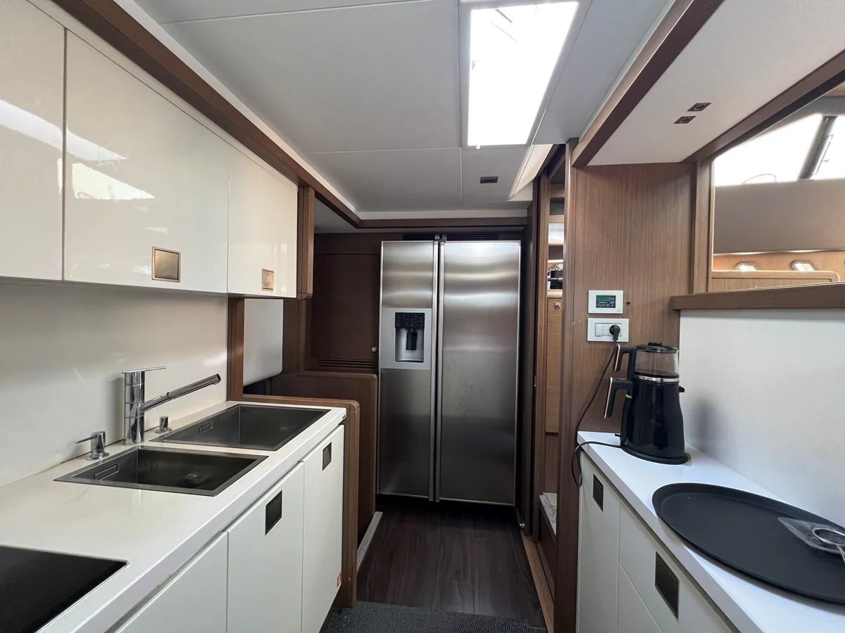 a kitchen with a stainless steel refrigerator aboard NGV Yacht for Sale