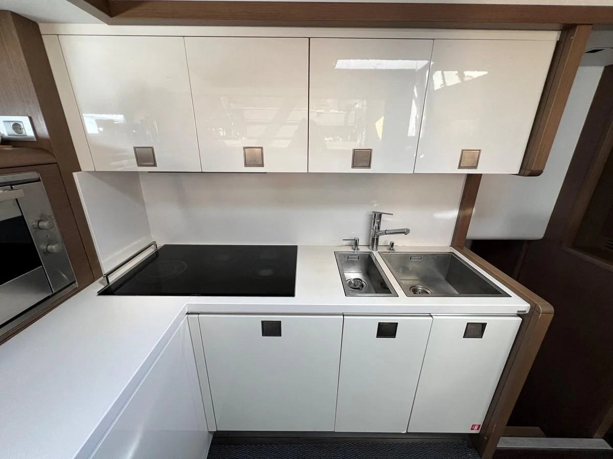 a kitchen with white cabinets aboard NGV Yacht for Sale