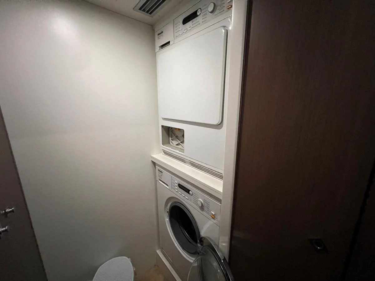 a small laundry room aboard NGV Yacht for Sale