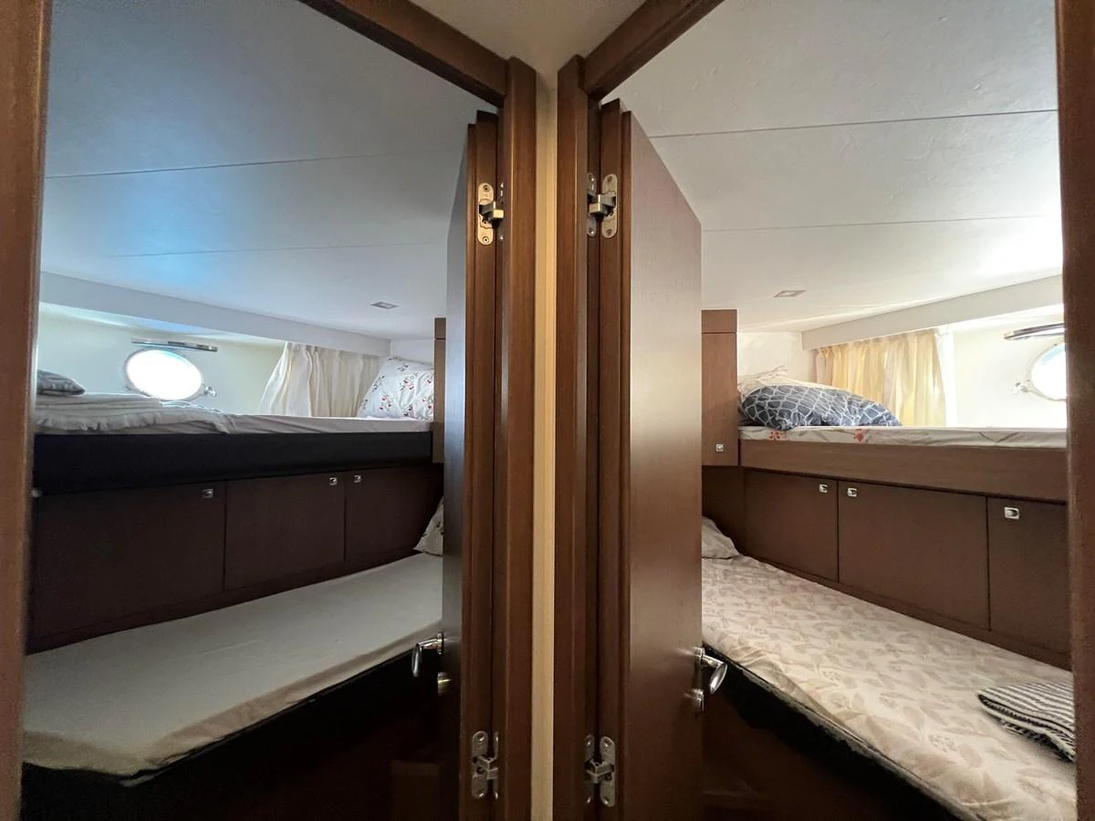 a room with bunk beds aboard NGV Yacht for Sale