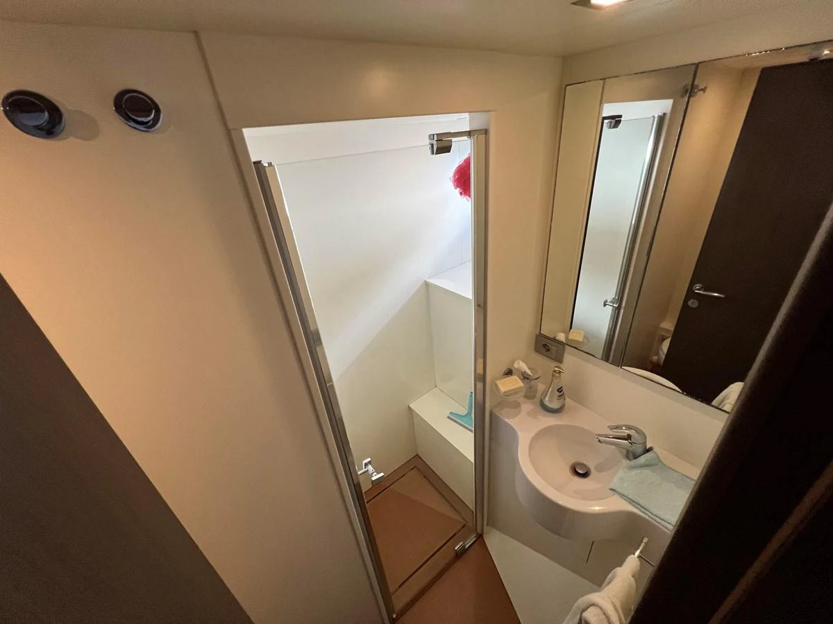 a bathroom with a large mirror aboard NGV Yacht for Sale
