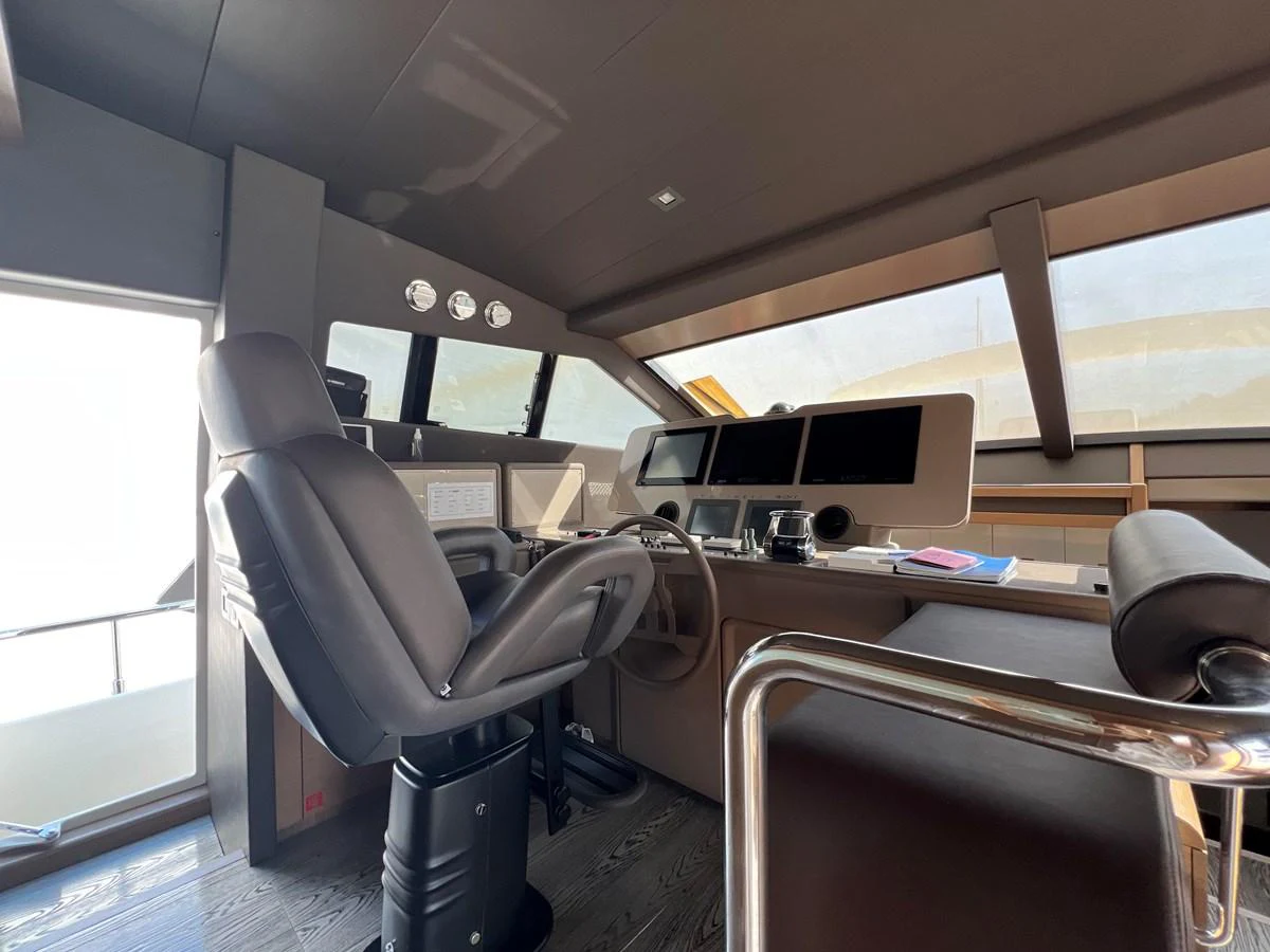 a room with a desk and chairs aboard NGV Yacht for Sale
