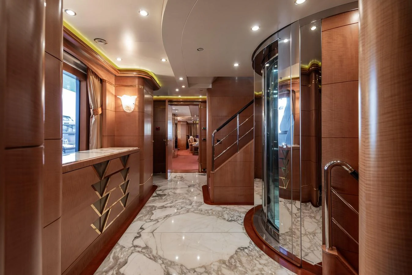 The yacht's interior features a luxurious hallway with marble flooring and elegant wood paneling. aboard MY SISA Yacht for Sale