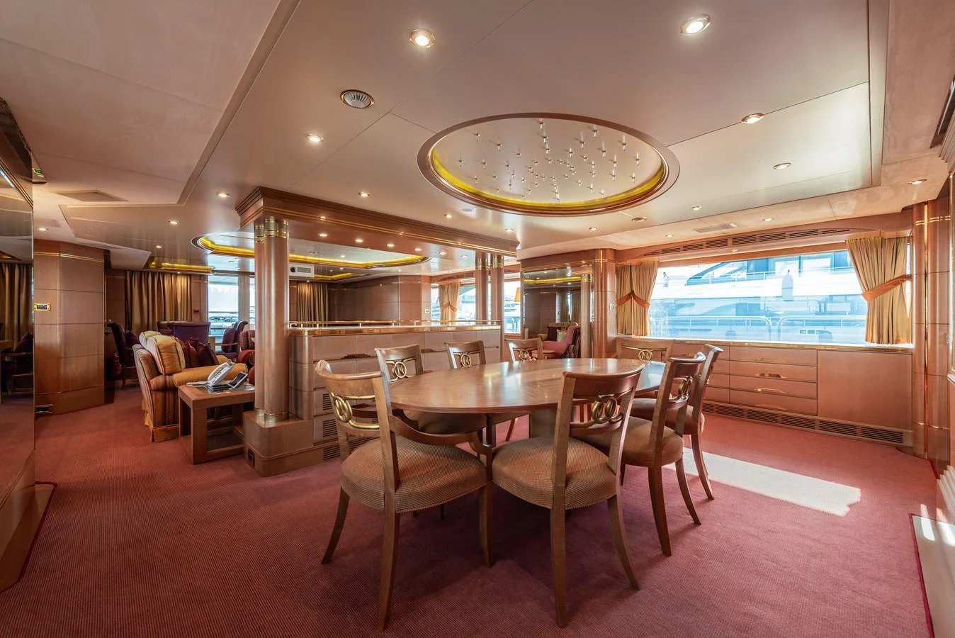 The yacht's dining area features elegant wooden furnishings and ample natural light. aboard MY SISA Yacht for Sale