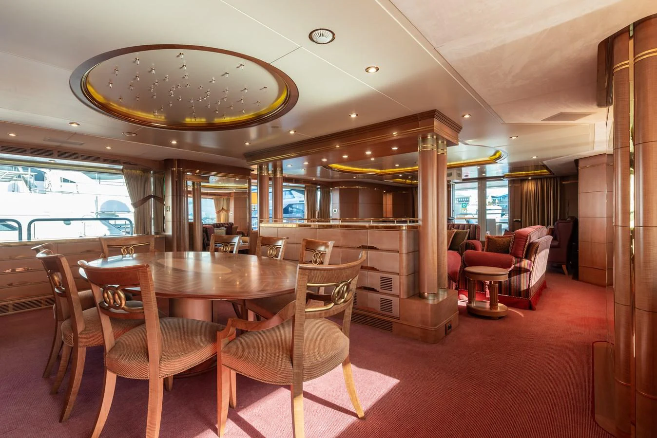The yacht's salon features elegant wooden furnishings and ample natural light. aboard MY SISA Yacht for Sale