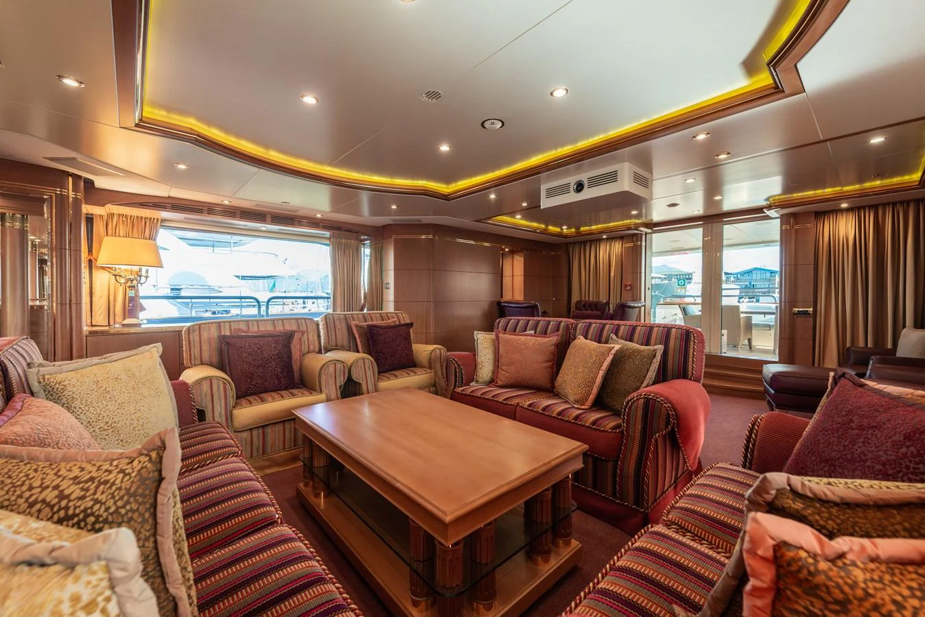 The salon features plush seating and warm lighting, creating a cozy and inviting atmosphere. aboard MY SISA Yacht for Sale