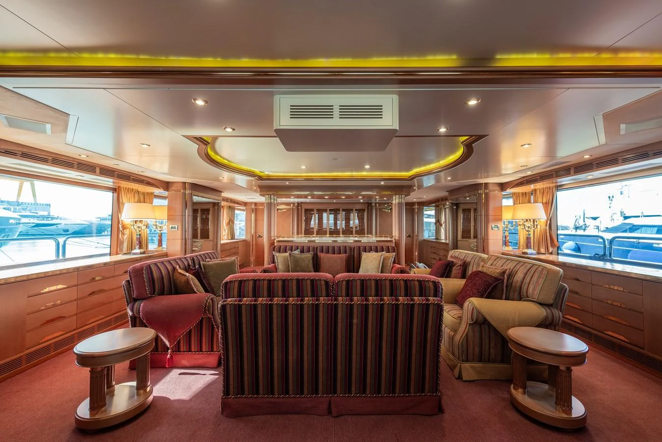The salon features luxurious seating with ample natural light and elegant decor. aboard MY SISA Yacht for Sale