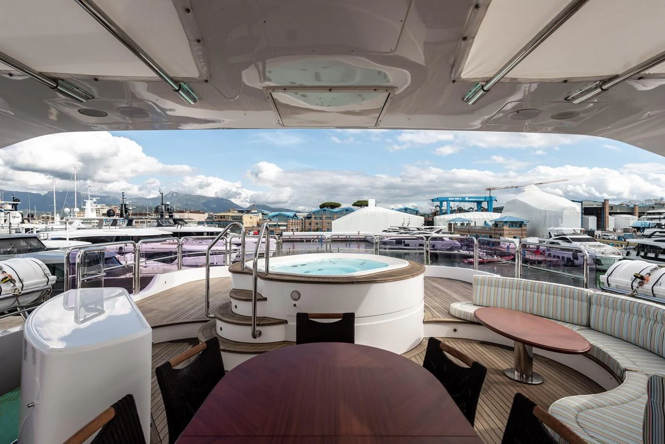 The sundeck features a luxurious hot tub with ample seating and a dining area, perfect for relaxation and entertainment. aboard MY SISA Yacht for Sale