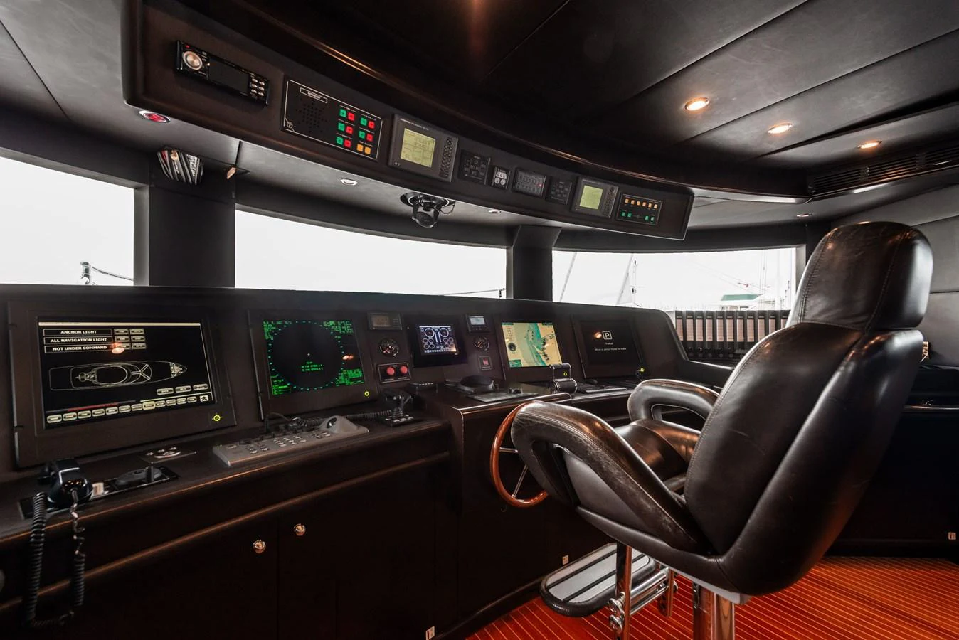 The helm station features advanced navigation equipment and a comfortable captain's chair. aboard MY SISA Yacht for Sale