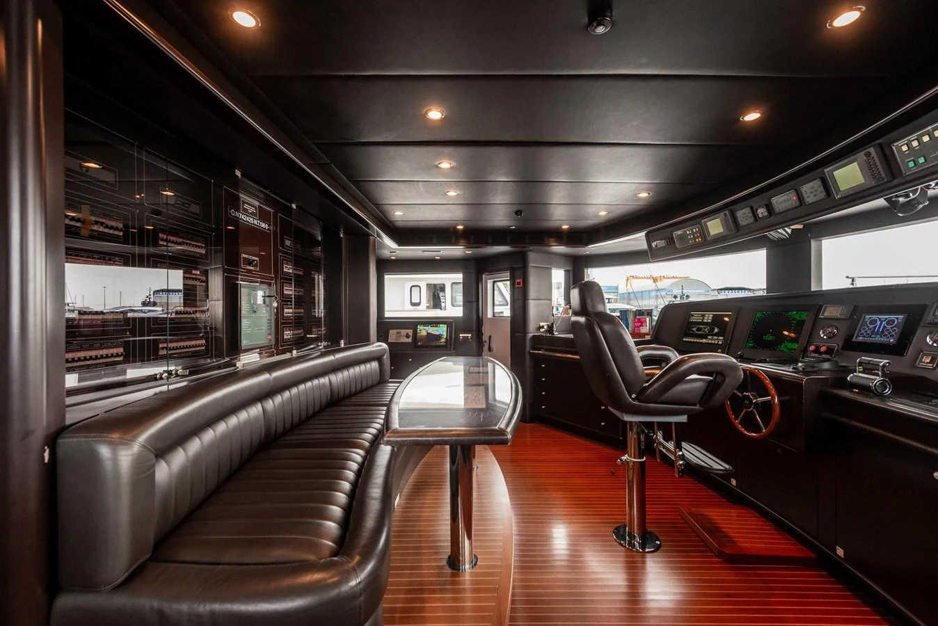 The helm station features a sleek, modern design with advanced navigation equipment and luxurious seating. aboard MY SISA Yacht for Sale