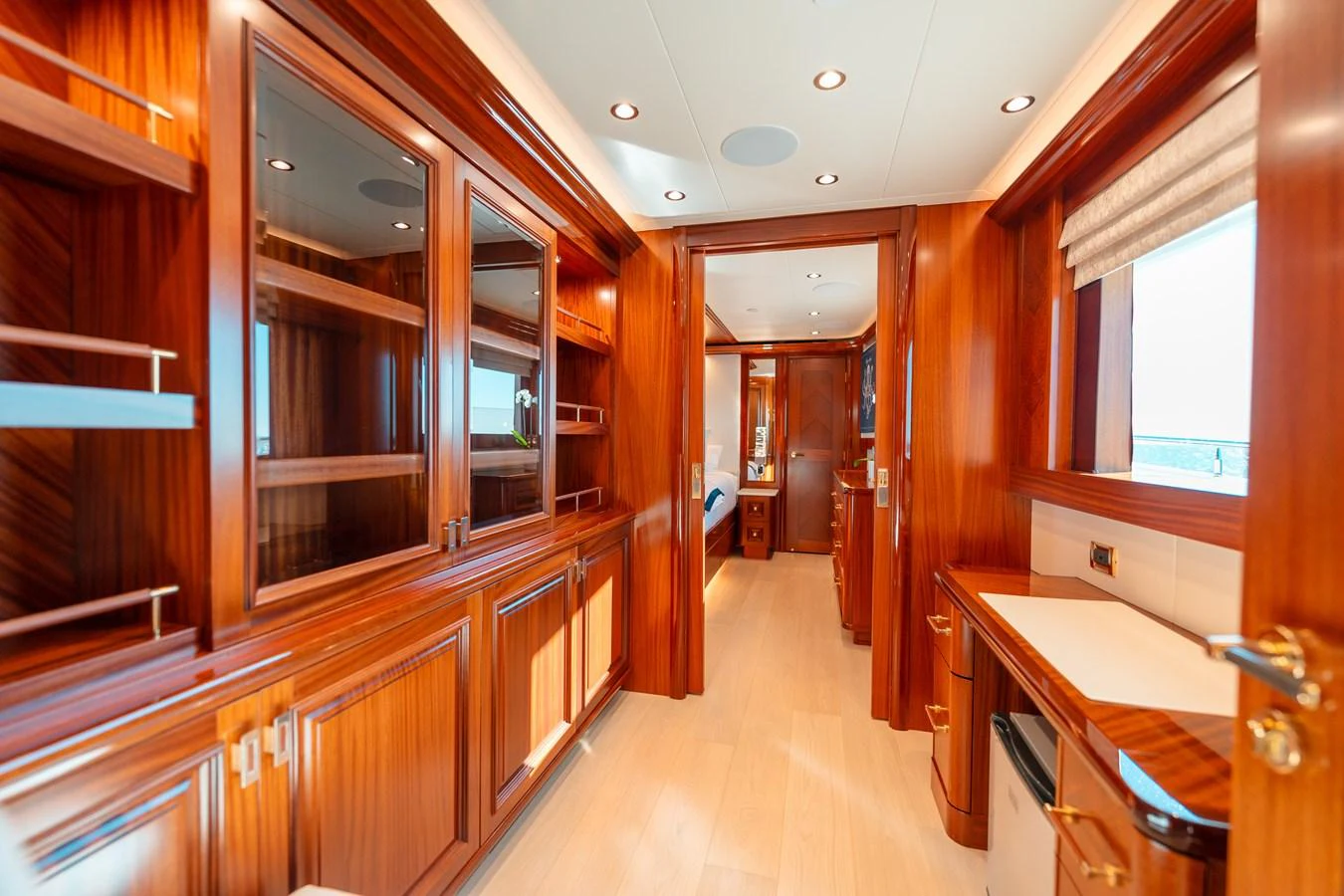 a long hallway with wood cabinets aboard BLUE TIME Yacht for Sale