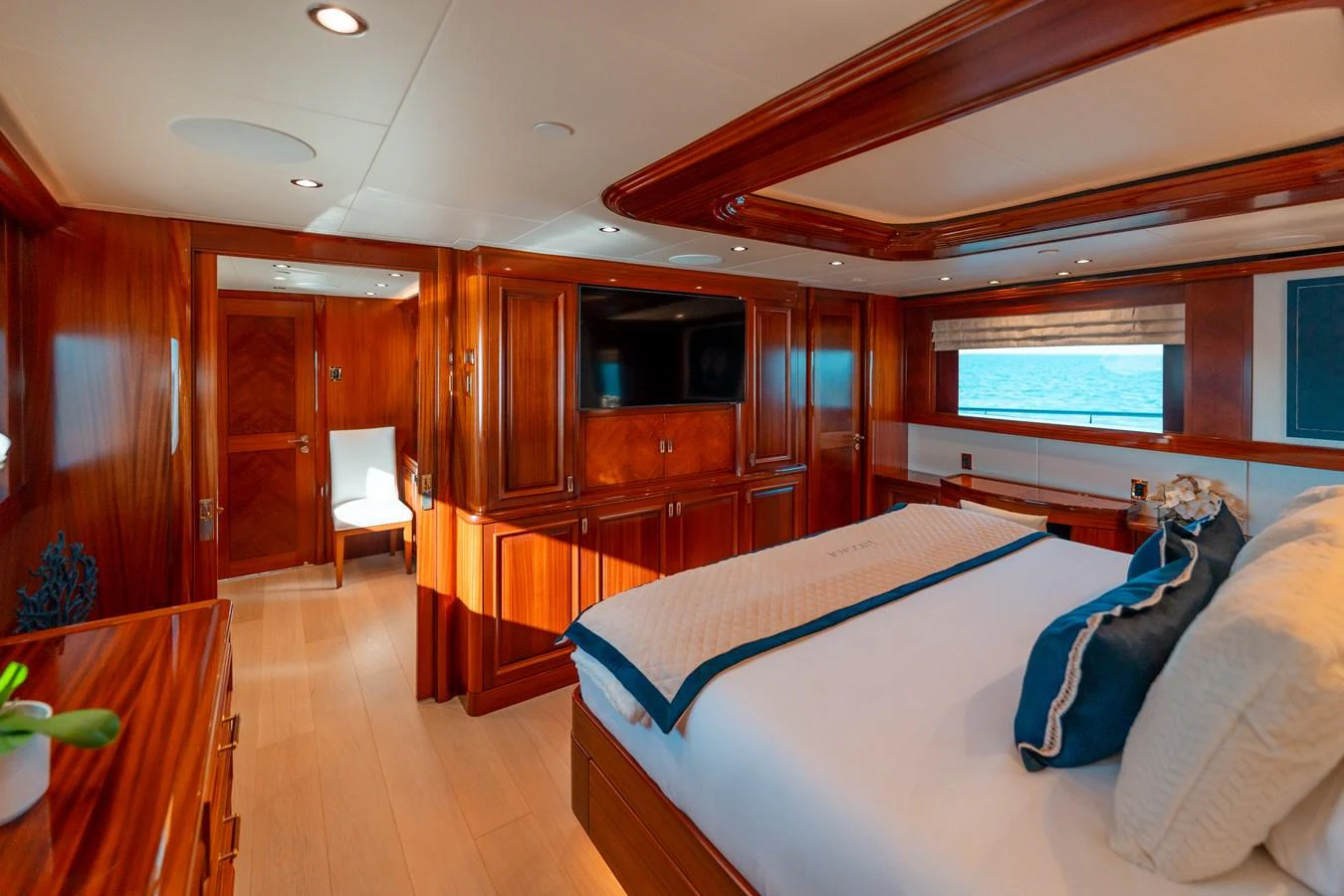 a bedroom with wood furniture aboard BLUE TIME Yacht for Sale
