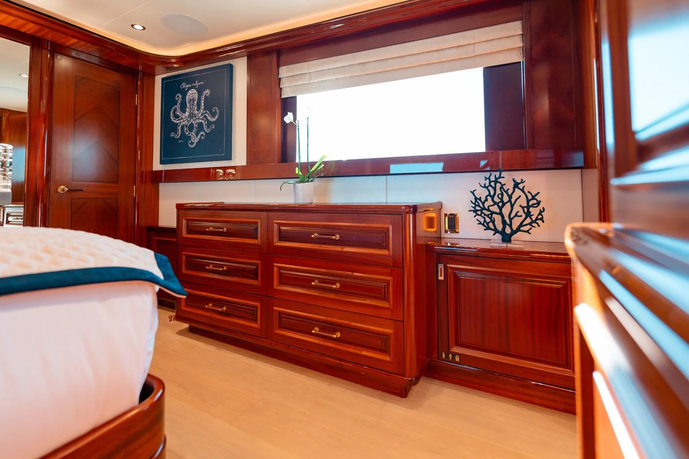 a bedroom with wooden cabinets aboard BLUE TIME Yacht for Sale