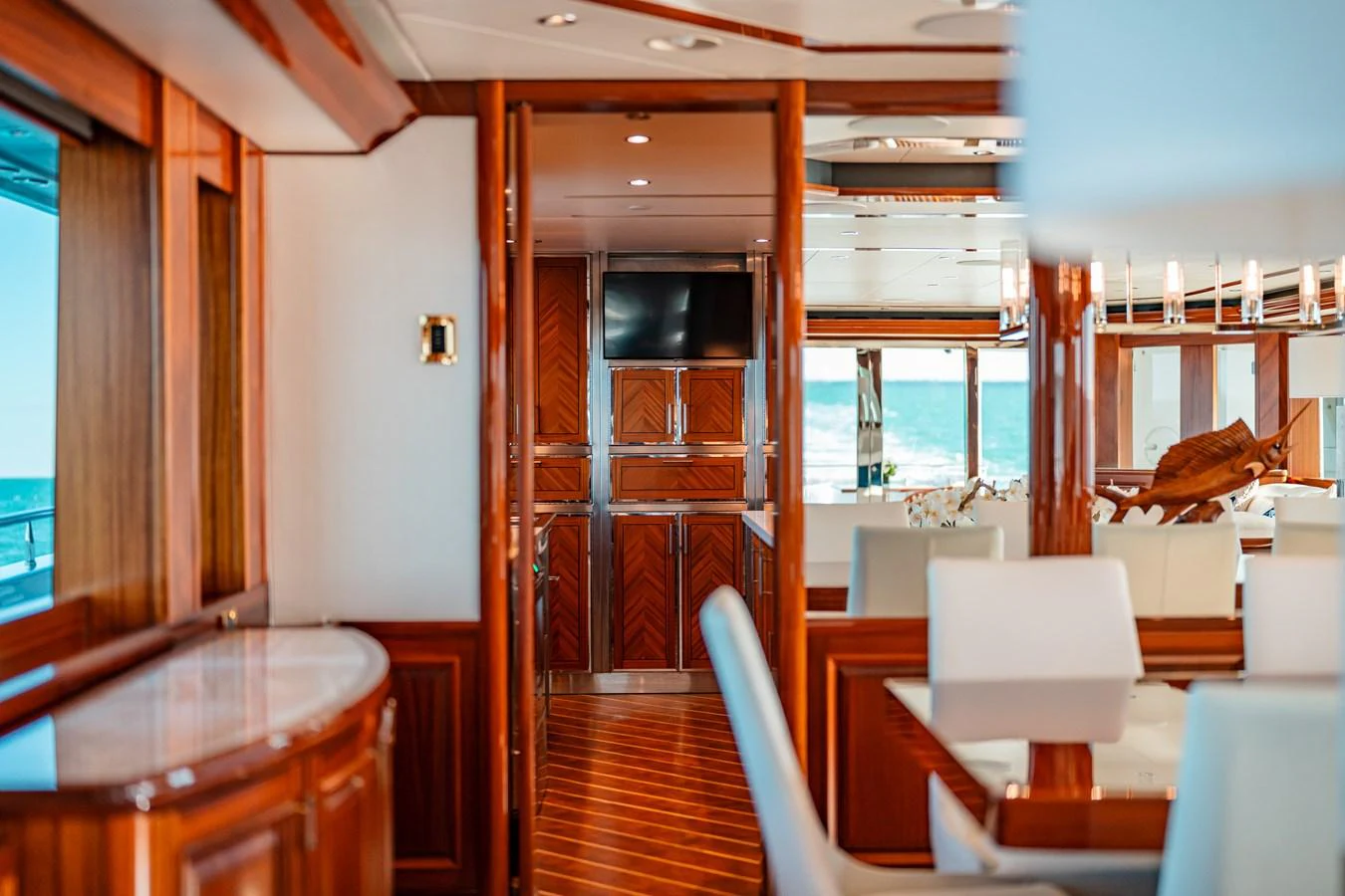 a room with a wood door and a table with chairs and a window aboard BLUE TIME Yacht for Sale