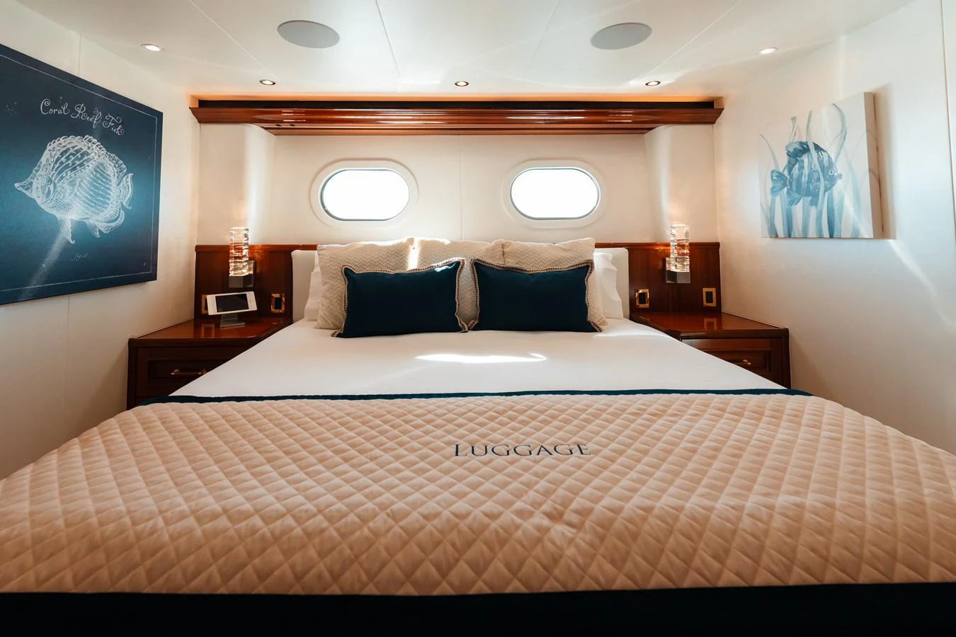 a bed with a white and brown comforter and pillows aboard BLUE TIME Yacht for Sale
