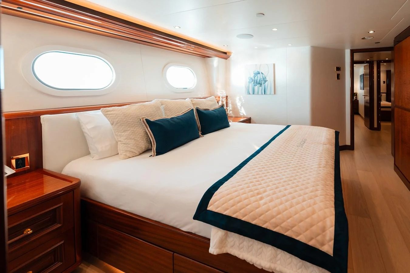 a bed with a blue and white striped blanket aboard BLUE TIME Yacht for Sale