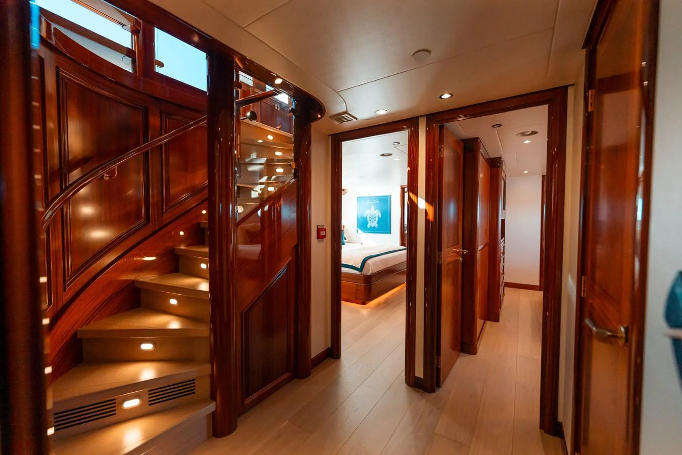 a room with a wood door and a bed in it aboard BLUE TIME Yacht for Sale