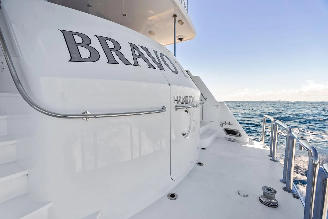 The aft deck of the yacht features sleek, modern design elements with a view of the open sea. aboard BRAVO ZULU Yacht for Sale