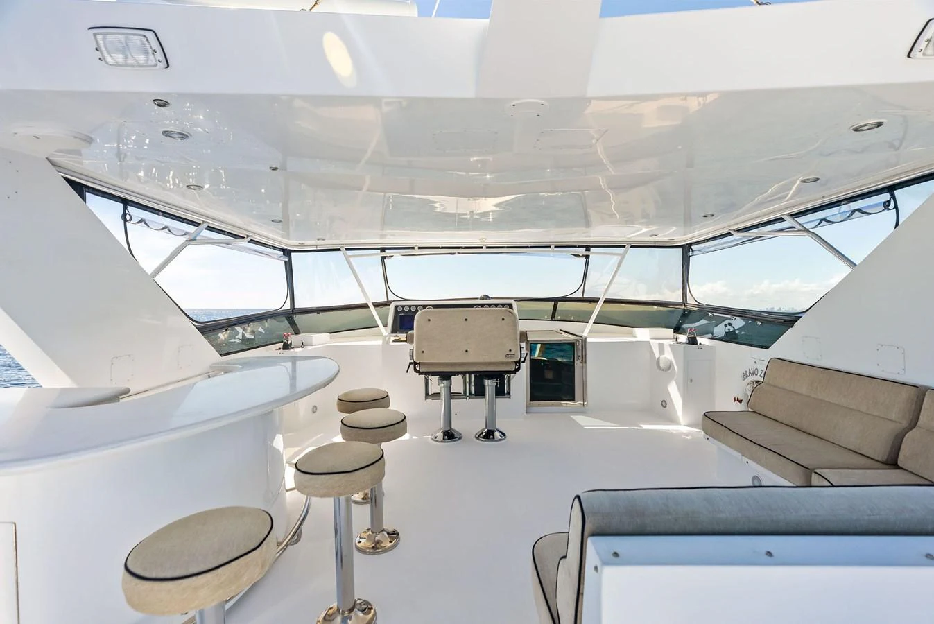 The flybridge offers a spacious and modern area for relaxation and entertainment with ample seating and a sleek design. aboard BRAVO ZULU Yacht for Sale