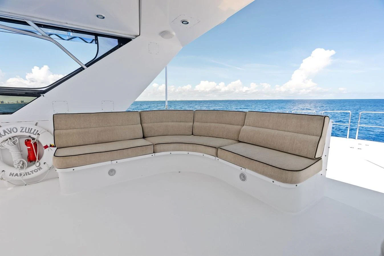 The aft deck features a spacious and comfortable seating area with a stunning ocean view. aboard BRAVO ZULU Yacht for Sale