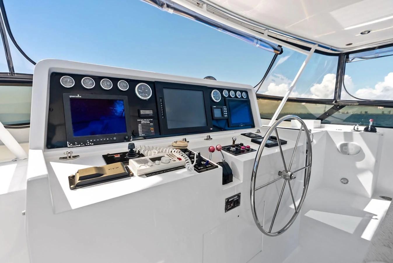 The helm station features advanced navigation equipment and a sleek steering wheel, offering a commanding view of the surroundings. aboard BRAVO ZULU Yacht for Sale
